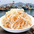 Bowl of translucent jellyfish strips on a harbour quay